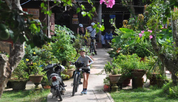 Boat, people, nature, peace, farm, and biking paths along the Mekong River in Vietnam